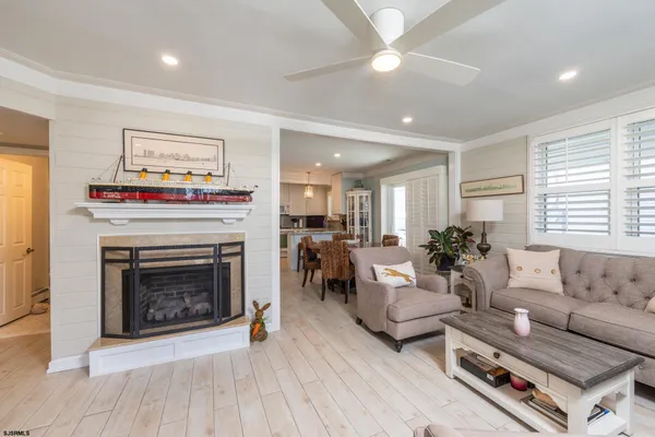 a living room with furniture a fireplace and a window