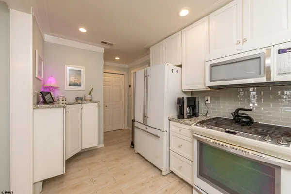 a kitchen with cabinets and stainless steel appliances