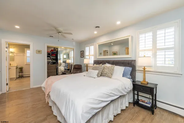 a bedroom with a large bed and a window