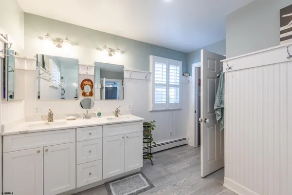 a bathroom with a double vanity sink and mirror