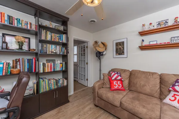 a living room with furniture and a book shelf