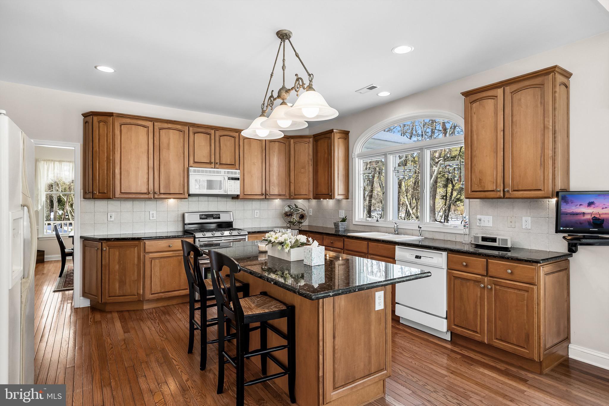 19 Big Look Trail Medford, NJ 08055 - Photo 16 of 61 a kitchen with granite countertop wooden floors and wooden cabinets
