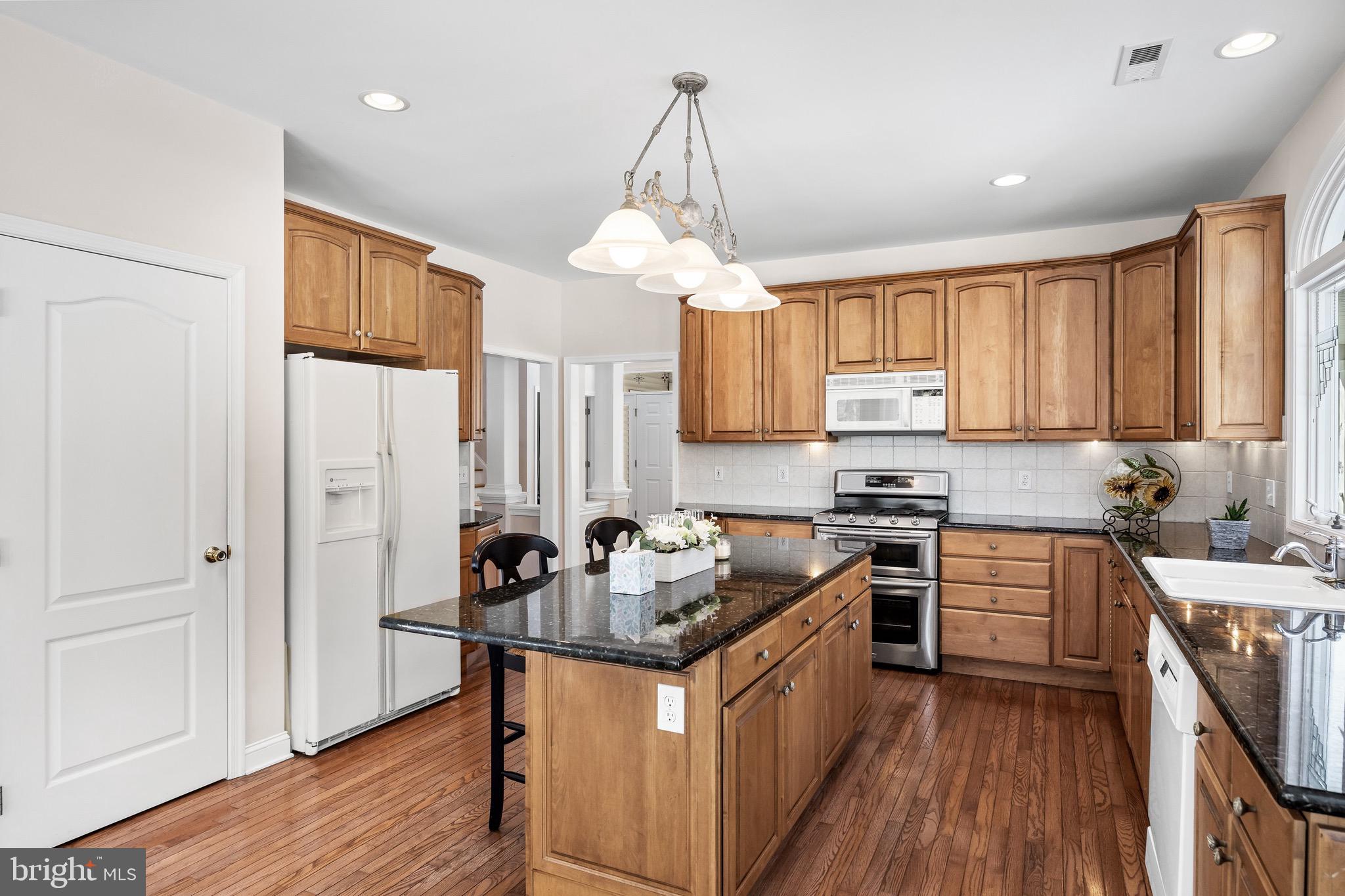 19 Big Look Trail Medford, NJ 08055 - Photo 18 of 61 a kitchen with stainless steel appliances granite countertop a stove a sink dishwasher a refrigerator and white cabinets with wooden floor