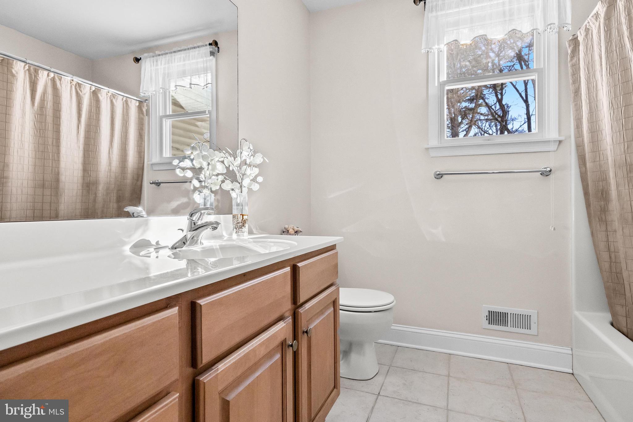 19 Big Look Trail Medford, NJ 08055 - Photo 35 of 61 a bathroom with a sink a toilet and shower curtain