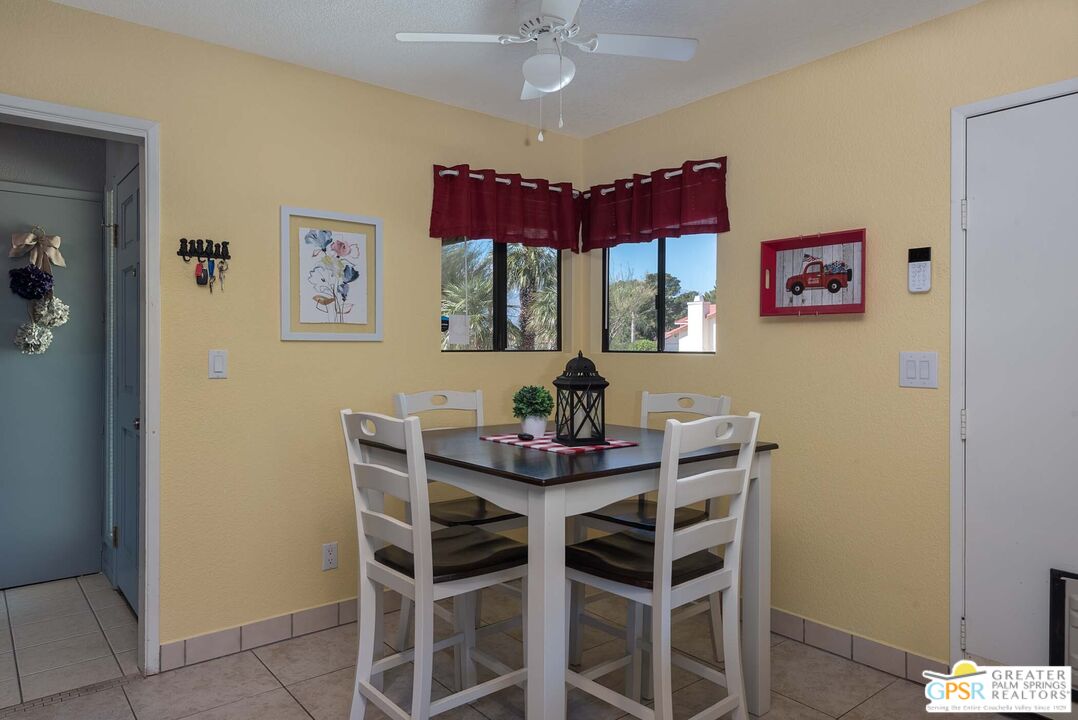 9760 Capiland Road Desert Hot Springs, CA 92240 - Photo 9 of 16 a view of a dining room with furniture and chandelier