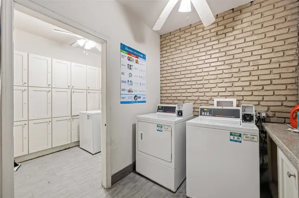 a view of a storage & utility room with dryer and washer