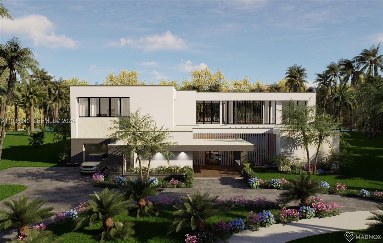 a front view of a house with garden and sitting area