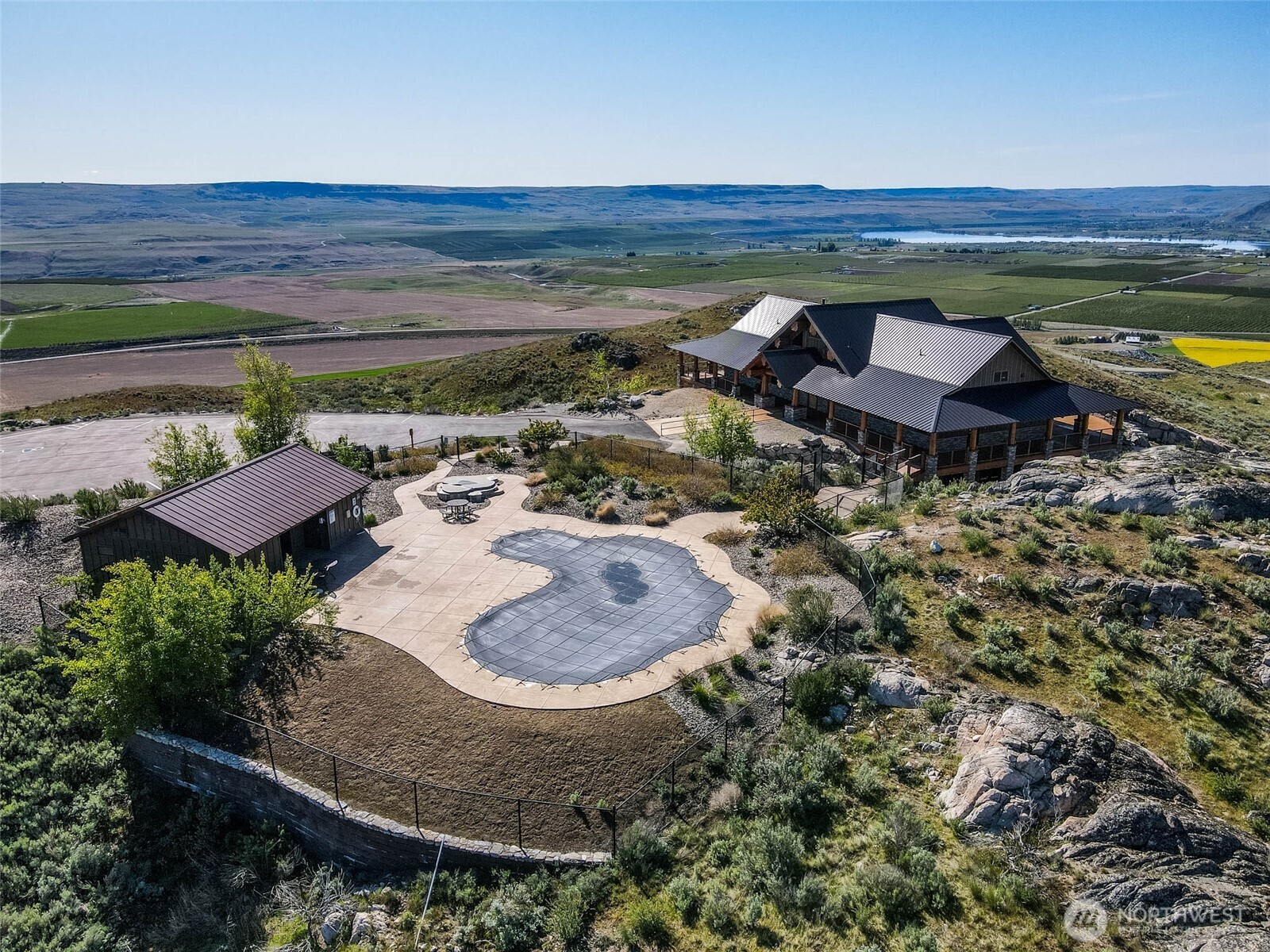0 Plata Road Brewster, WA 98812 - Photo 17 of 28 a view of a backyard with a table and chairs under an umbrella