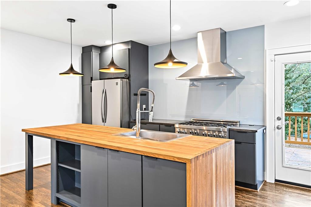 2188 Edison Avenue Northeast Atlanta, GA 30305 - Photo 15 of 51 a kitchen with a sink a stove and a wooden floor