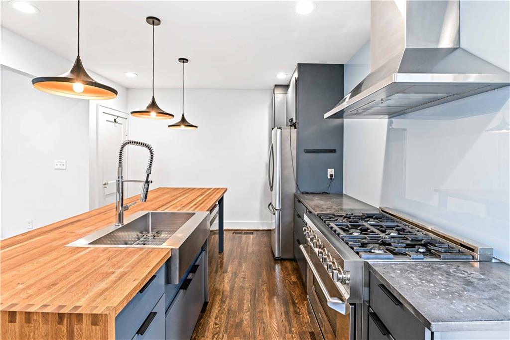 2188 Edison Avenue Northeast Atlanta, GA 30305 - Photo 16 of 51 a kitchen with stainless steel appliances granite countertop a sink stove and refrigerator