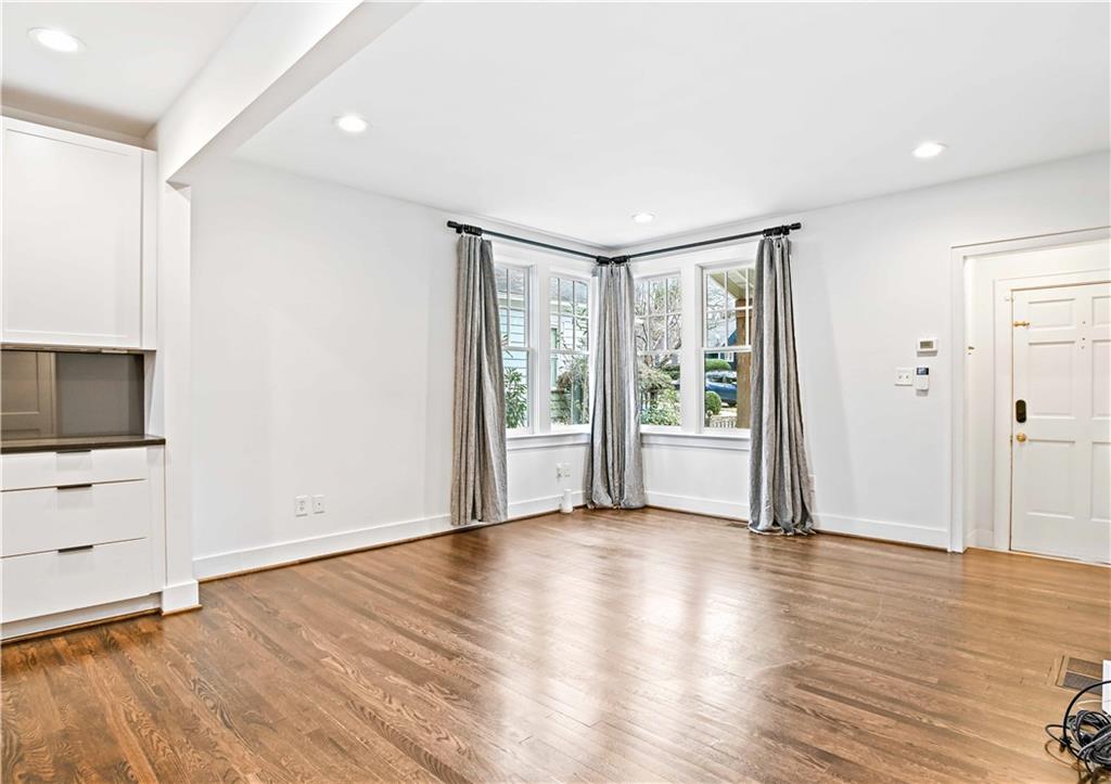 2188 Edison Avenue Northeast Atlanta, GA 30305 - Photo 10 of 51 a view of an empty room with wooden floor and a window