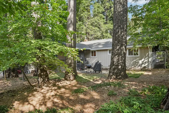 a view of a house with backyard and sitting area