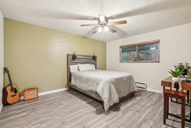 a bedroom with a bed and wooden floor