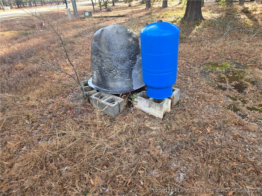 2222 Sand Hill Road Hope Mills, NC 28348 - Photo 3 of 12 a picture of a bench in a yard