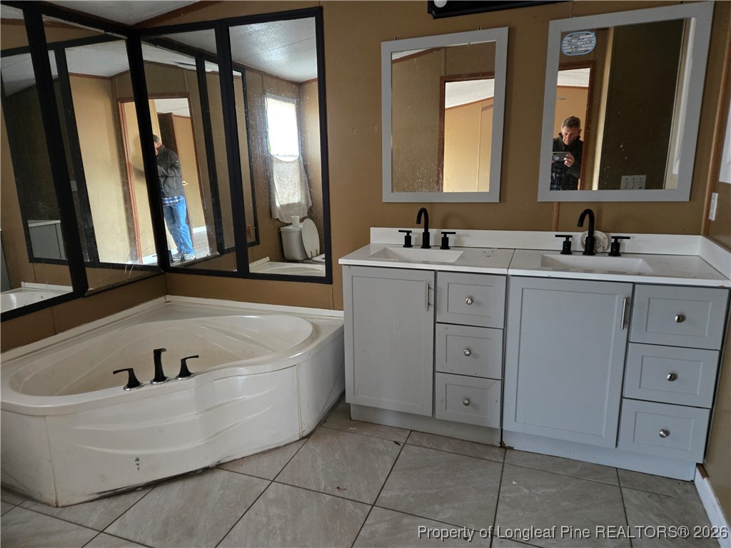 2222 Sand Hill Road Hope Mills, NC 28348 - Photo 6 of 12 a bathroom with a tub sink and mirror