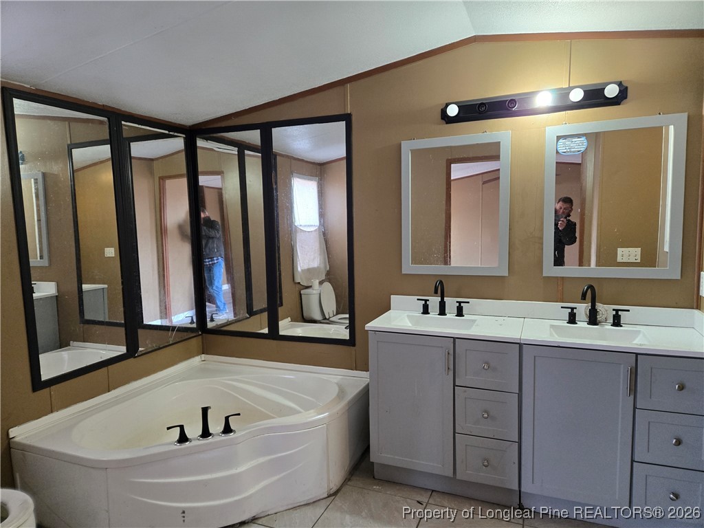 2222 Sand Hill Road Hope Mills, NC 28348 - Photo 8 of 12 a bathroom with a tub sink and mirror