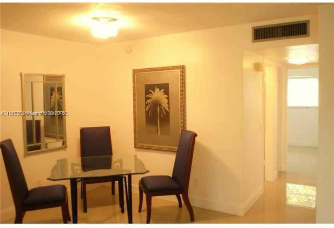 2451 Southwest 82nd Avenue, Unit 106 Davie, FL 33324 - Photo 6 of 10 a view of a dining room with furniture and a window