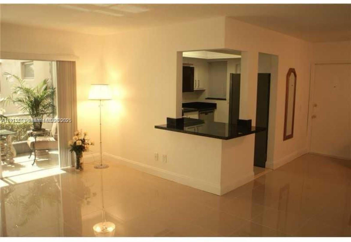 2451 Southwest 82nd Avenue, Unit 106 Davie, FL 33324 - Photo 7 of 10 a hallway with a large window and in a room