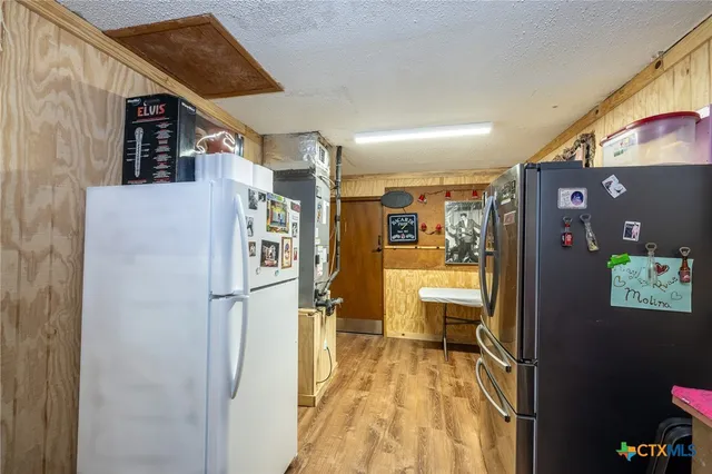 a view of a living room with a refrigerator and a couch