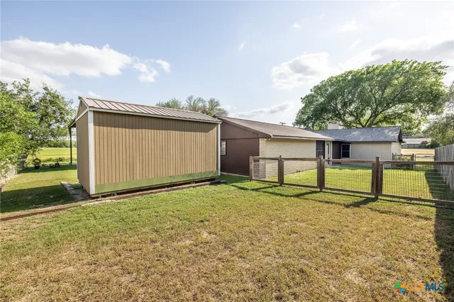 a backyard of a house with yard and barbeque oven