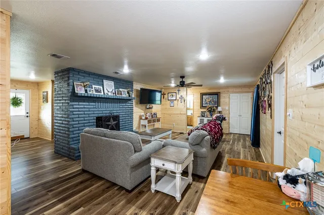 a living room with furniture and a fireplace
