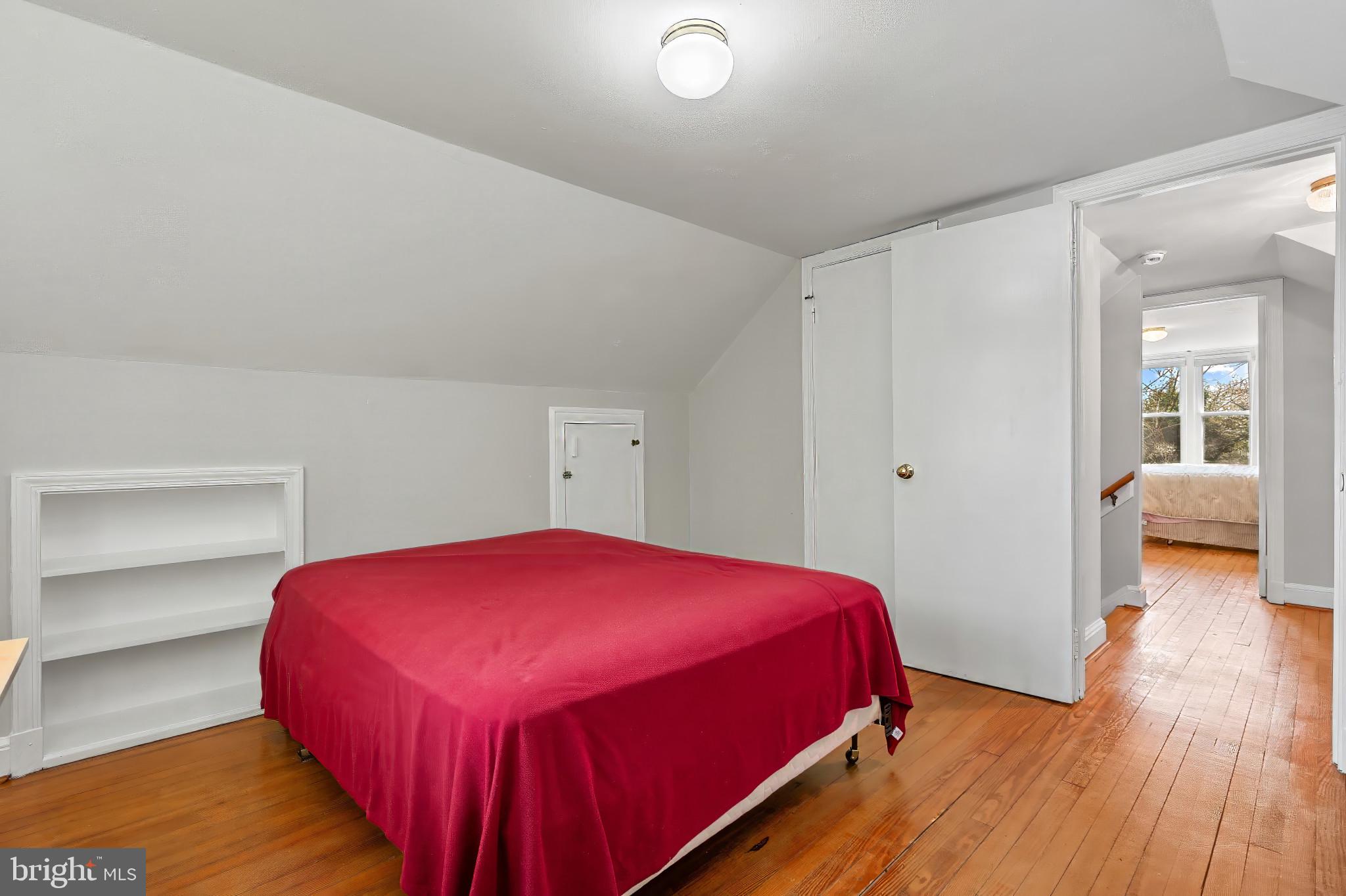 9704 Lorain Avenue Silver Spring, MD 20901 - Photo 20 of 43 a bedroom with a bed and wooden floor