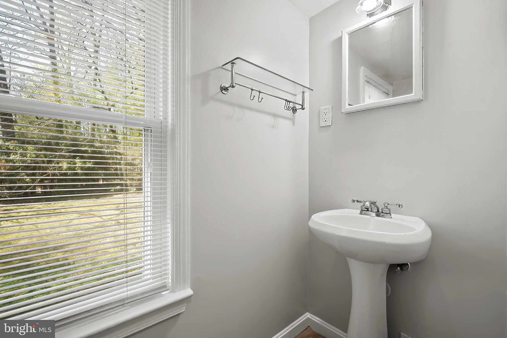 9704 Lorain Avenue Silver Spring, MD 20901 - Photo 21 of 43 a bathroom with a sink a mirror and a shower