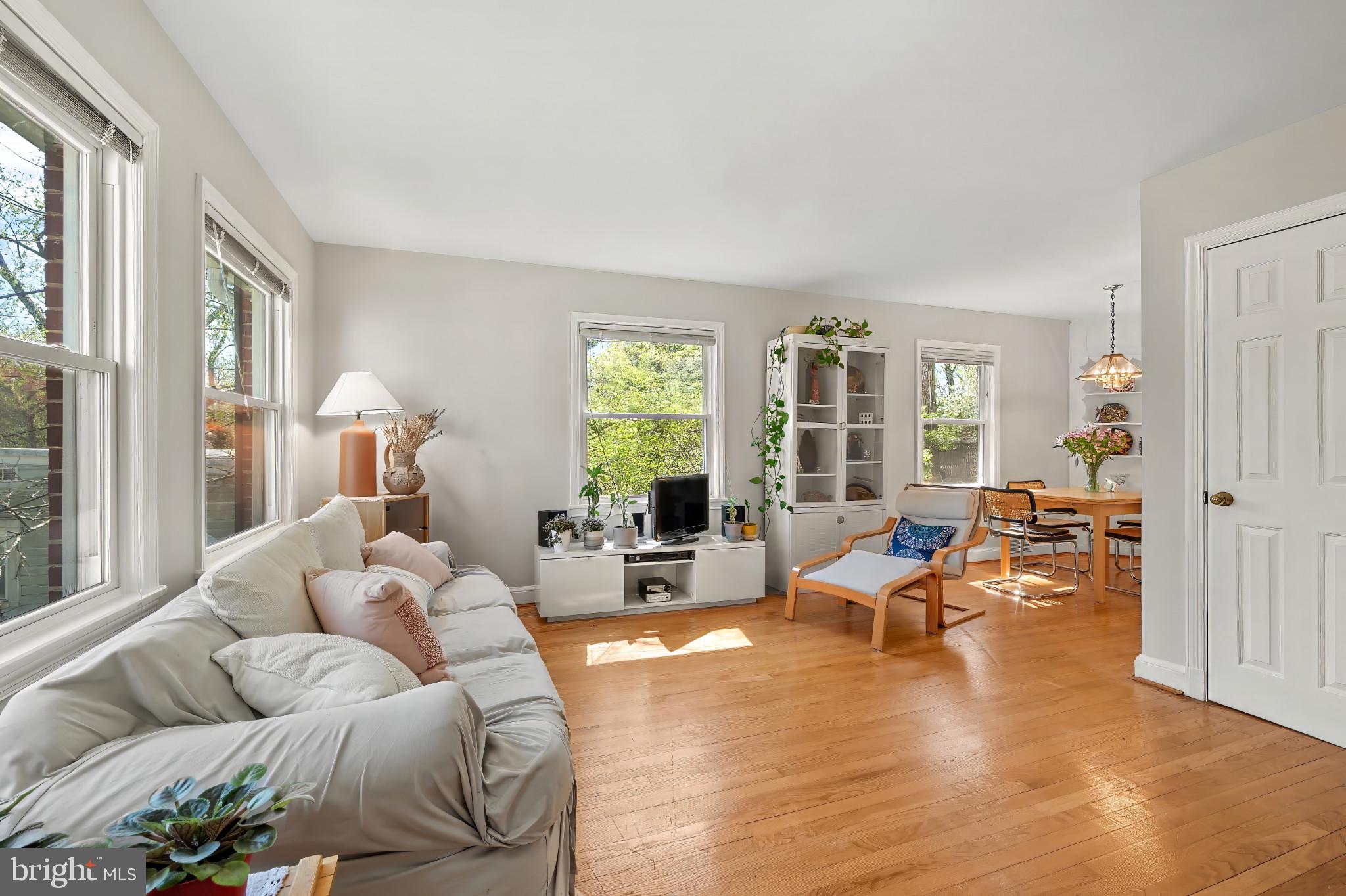 9704 Lorain Avenue Silver Spring, MD 20901 - Photo 43 of 43 a living room with furniture floor to ceiling window and wooden floor