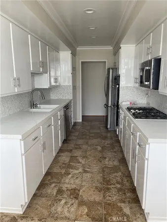 a kitchen with a sink stove and cabinets