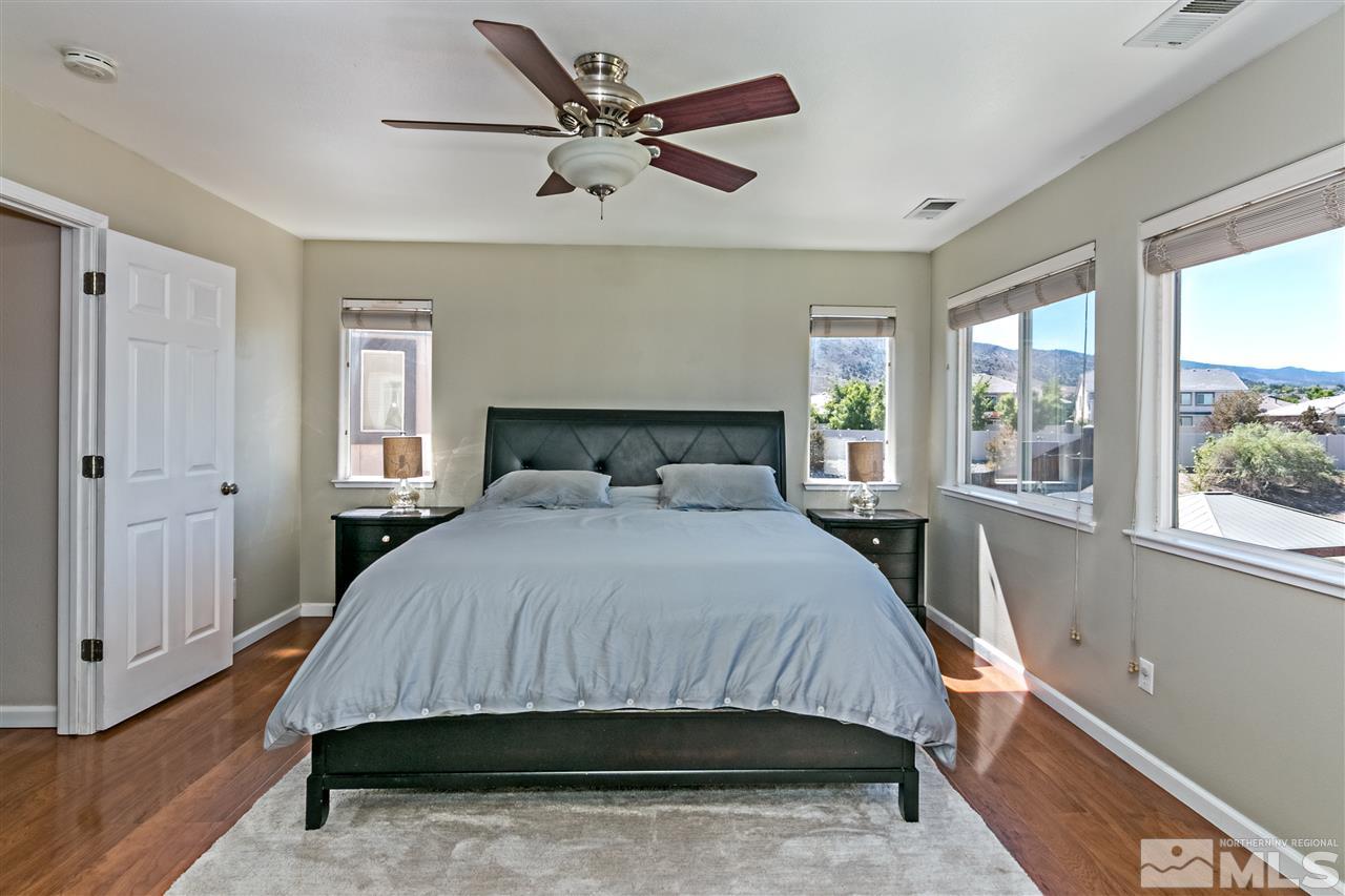 2330 Clementine Lane Reno, NV 89521 - Photo 14 of 32 a bedroom with a large bed and a window