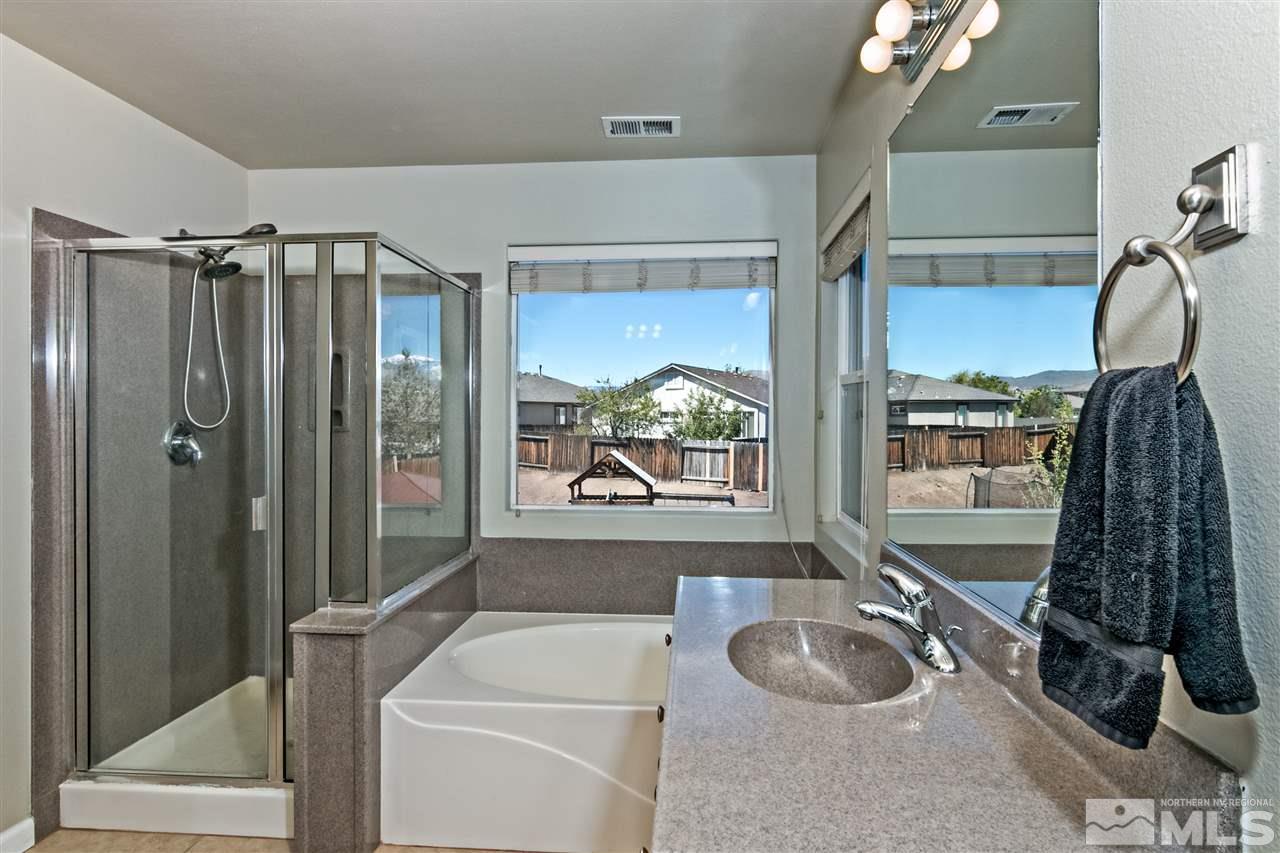 2330 Clementine Lane Reno, NV 89521 - Photo 16 of 32 a bathroom with a granite countertop sink a toilet and shower