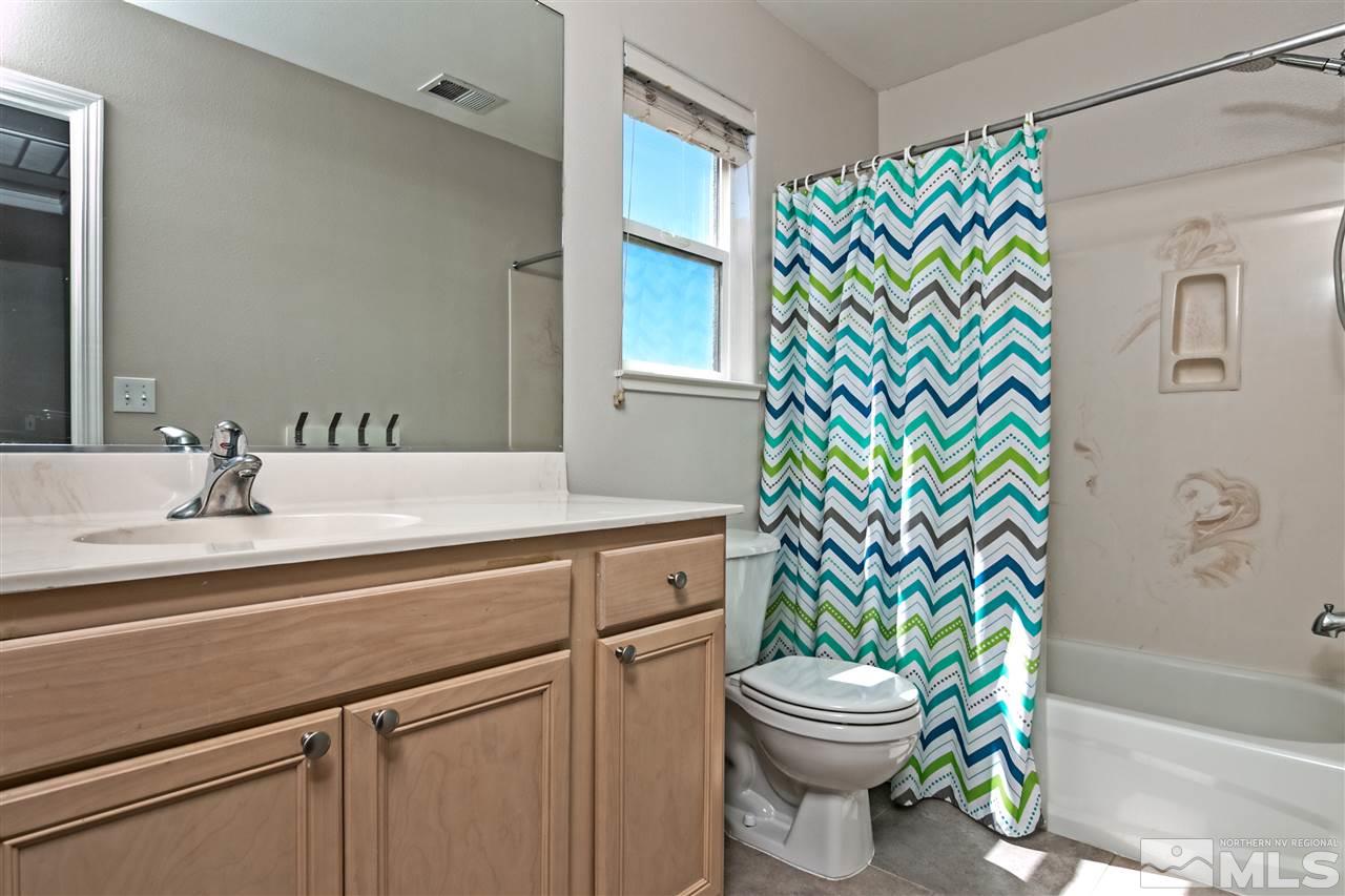 2330 Clementine Lane Reno, NV 89521 - Photo 21 of 32 a bathroom with a sink mirror vanity and toilet