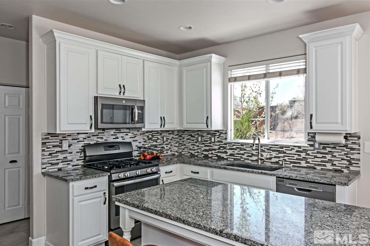 2330 Clementine Lane Reno, NV 89521 - Photo 10 of 32 a kitchen with sink a stove and white cabinets