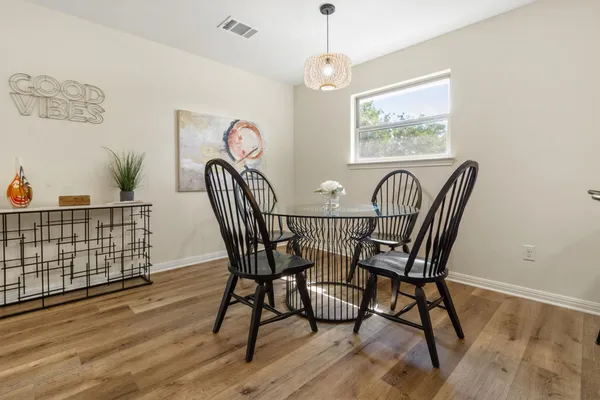 a view of a dining room with furniture wooden floor and chandelier