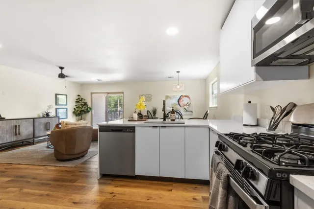 a kitchen with stainless steel appliances granite countertop a stove and a sink
