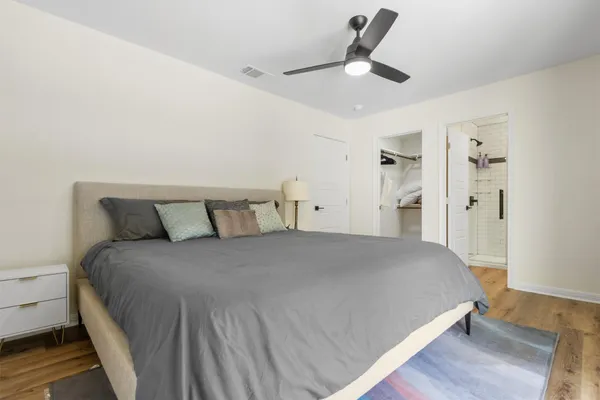 a bed room with a bed and a ceiling fan