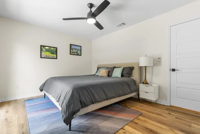 a bedroom with a bed and a painting