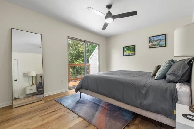 a bedroom with a large bed and a chandelier