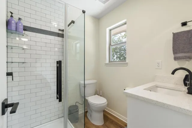 a bathroom with a toilet sink and shower