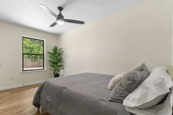 a bedroom with a bed and a window