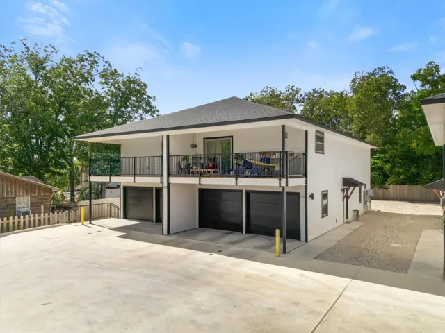 a view of a white house with a outdoor space