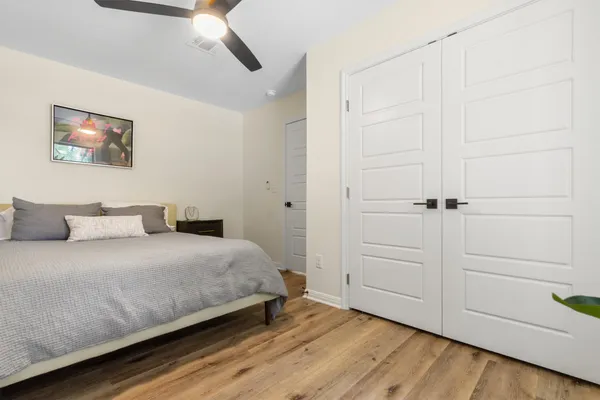 a bedroom with a bed and a cabinet