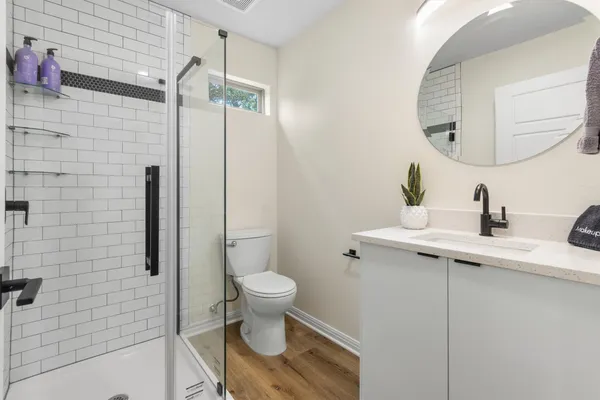 a bathroom with a sink toilet and shower