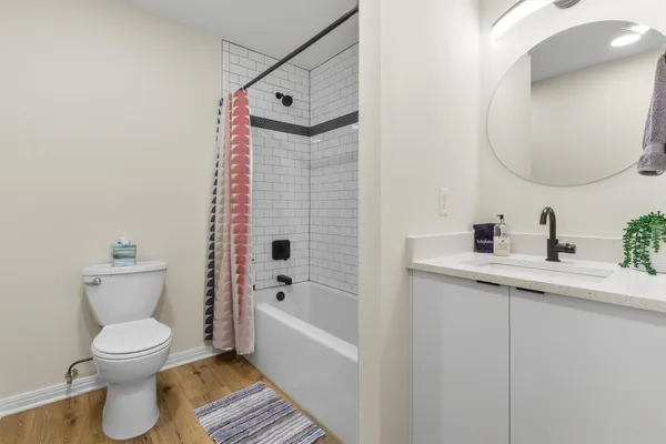 a white toilet sitting next to a bathroom sink