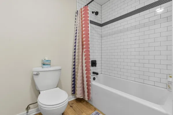 a bathroom with a toilet and bathtub
