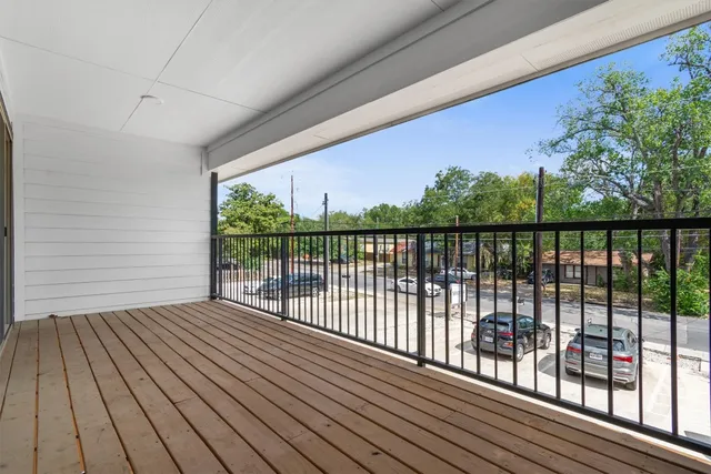 a view of balcony with wooden floor