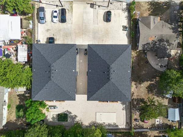 an aerial view of residential houses with outdoor space