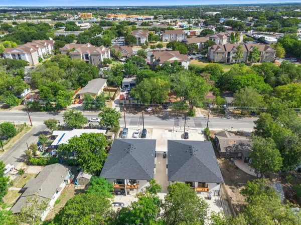 an aerial view of residential houses with city view