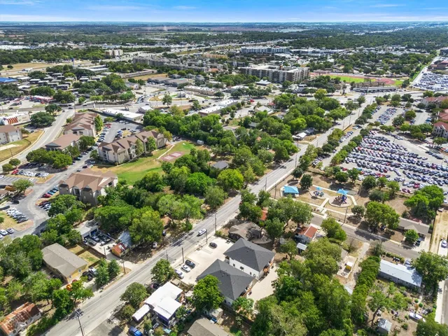 an aerial view of residential houses with city view
