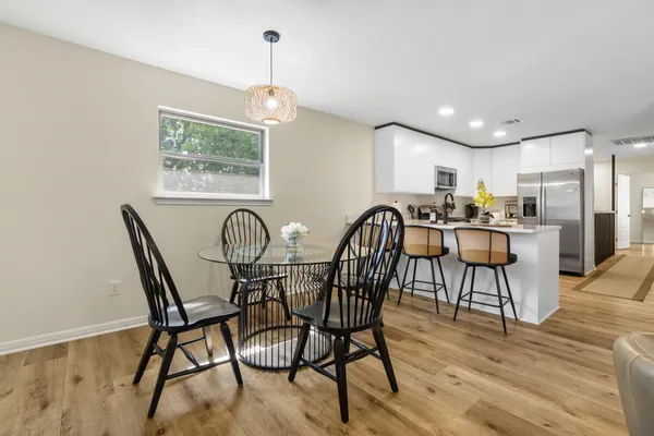 a view of a dining room with furniture and wooden floor